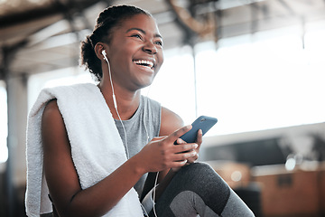 Image showing Earphones, smartphone and laughing black woman in gym for fitness, sports or exercise. Phone, music or African female athlete laugh at funny meme or comedy on break after workout, training or pilates