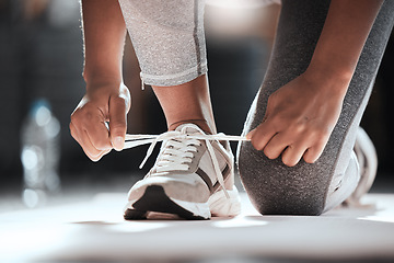 Image showing Hands, shoelaces and floor at gym with woman, fitness and ready for workout, wellness or training. Girl, sport shoes or sneakers for exercise, performance or health for lifestyle, motivation and club