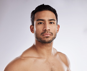 Image showing Confidence, portrait and young man in a studio after a workout or body strength training. Serious, sports and face of attractive male model with muscles after exercise isolated by a white background.