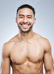 Image showing Portrait of man in shower with smile, cleaning and hygiene for healthy body and studio backdrop. Water, skin and hair care, happy male model washing with skincare on background with bathroom spa.