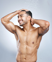 Image showing Man in shower with smile, cleaning and water for hygiene with shampoo, healthy body and studio backdrop. Beauty, skin and hair care, happy male model washing with muscle on bathroom background spa.