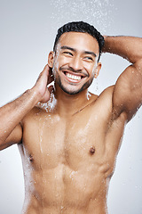 Image showing Man in shower with smile, cleaning and studio background for hygiene with shampoo, healthy body. Water, skin and hair care, happy male model washing with happiness on backdrop with bathroom spa time.