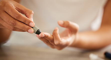 Image showing Finger, diabetes and a person checking their blood sugar level in a home closeup for routine treatment. Hands, test and medical equipment with a diabetic adult taking a sample to check glucose