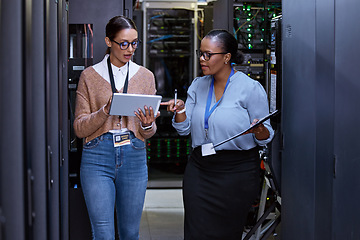 Image showing Talking, server room and women with a tablet for cyber security, database planning and inspection. Teamwork, technician and female programmers speaking with technology for coding, hardware and system