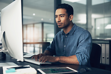 Image showing Typing, man and programmer on computer in office at night for deadline. IT, focus and male coder, engineer or person programming, coding and writing software, development and information technology.