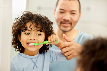 Image showing Child, brushing teeth and father learning in a bathroom with dental health and cleaning. Morning routine, toothbrush and kid with dad together showing hygiene care at a mirror at home with grooming