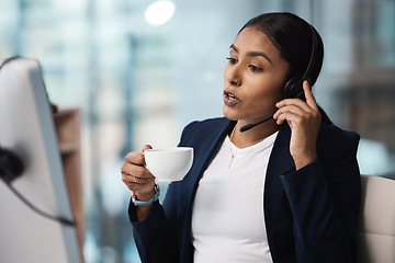 Image showing Call center, customer service and coffee with a business woman using a headset while consulting at work. Support, contact us or crm with a young female employee consulting in her telemarketing office