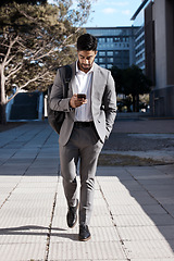 Image showing Phone, city and Indian business man walking for travel, social media or internet search. Smartphone, texting and male person on walk in town while checking app, message or text on commute in street