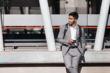 Image showing Phone, texting and Indian business man in a city for travel, social media and internet search, Smartphone, browsing and male person relax while checking app, message or text on commute in New York