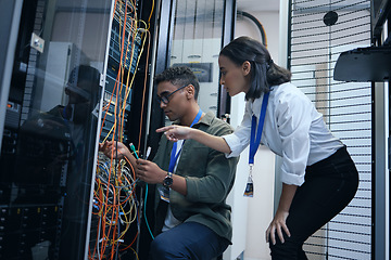 Image showing IT people, engineer or server room cable for programming or connection maintenance. Man and woman technician in datacenter for network, cybersecurity software or data center problem or system upgrade