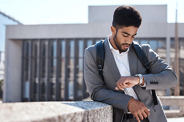 Image showing Watch, time and corporate businessman in the city for cab, taxi or public transport to work. Travel, professional or young male employee waiting with a backpack in an urban town for commuting to work