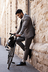 Image showing Bicycle, relax and happy business man in city for carbon neutral, sustainable and transport. Bike, commute and Indian male person on cycling break, smile and resting while traveling alone in Europe