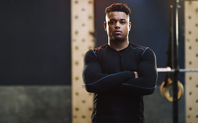 Image showing Crossed arms, exercise and portrait of man in gym for training, fitness and bodybuilder workout. Motivation, muscles and serious male person in sports center for challenge, wellness and body strength