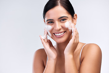 Image showing Beauty, foam wash and portrait of a woman in a studio for natural, cosmetic and skincare routine. Wellness, smile and female model cleaning her face with facial cleanser isolated by white background