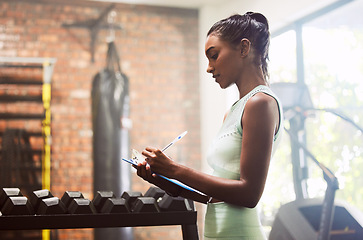 Image showing Exercise, personal trainer and woman in a gym, inventory and checklist for equipment, schedule and hygiene inspection. Female person, entrepreneur or athlete with documents, feedback and training