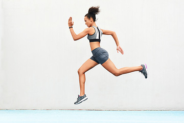 Image showing Woman, fitness and running on mockup of athlete in cardio training, workout or healthy exercise. Fit, active or sporty female person or runner exercising for health and wellness on wall mock up space