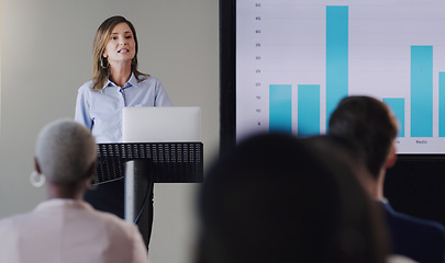 Image showing Woman speaker, conference and business graphs at a seminar, workshop or training. Professional men and women at a presentation with a podium for learning, knowledge and discussion for sales growth