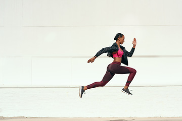 Image showing Woman, fitness and running jump action on mockup for cardio training, exercise or workout outdoors. Fit, active and sporty female person or runner exercising for health and wellness on mock up space