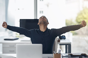 Image showing Business man, celebration and laptop with winning, achievement and success on stock market. Young indian businessman, pc and winner with fist to celebrate profit, bonus and online gambling at desk