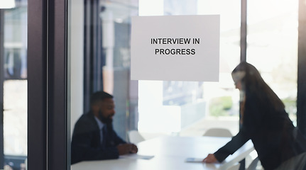 Image showing Recruitment, window sign and business people in an interview in the modern office boardroom. Hiring, meeting and professional corporate employees doing recruiting process in workplace conference room