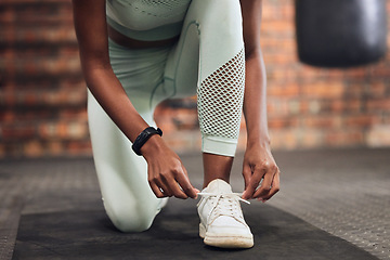 Image showing Tie, start or hands of woman with shoes at gym for training, exercise or workout motivation in fitness center. Lace, closeup or legs of girl sports athlete with footwear ready to begin exercising