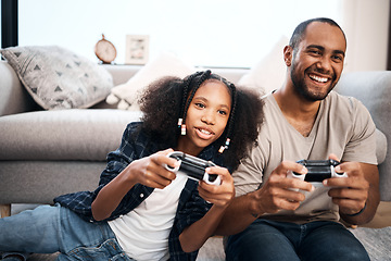 Image showing Video game, family or kids with a dad and daughter in the living room of their home playing or gaming together. Children, happy or fun with a gamer father and girl child in the house to play online