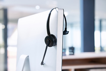 Image showing Empty office, computer or call center headset for communication for telecom customer services. Help desk, background or crm workplace for technical support, telemarketing sales or consulting job