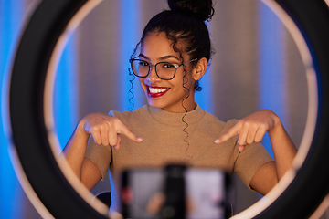 Image showing Influencer woman, ring light and portrait with smile, pointing and beauty on live stream, broadcast or web video. Girl, review or online entrepreneur with happiness, makeup or talking on social media