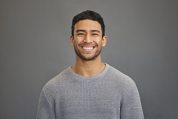 Image showing Portrait of man in studio with smile, happy mindset on studio backdrop in Indonesia and casual fashion. Relax, confidence and natural face of calm Asian male model on grey background with happiness.