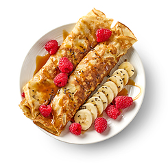 Image showing freshly baked crepes with fresh fruits and caramel sauce