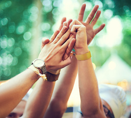 Image showing Closeup, hands together and group at event, music festival and outdoor for fun, bonding and collaboration. Zoom, hand and people outside, partying and celebration with social gathering and concert