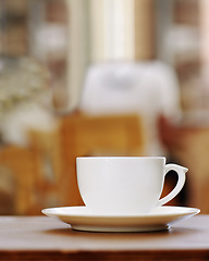 Image showing Closeup of one coffee cup on table in a cafe, hot beverage and caffeine drink for breakfast or energy. Espresso, cappuccino and latte in hospitality industry with ceramic teacup and cacao liquid