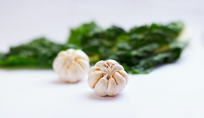 Image showing Vegetable, garlic clove and healthy food in studio as art or creativity for nutritionist. Cooking, wellness diet and nutrition for clean, green or vegan meal ingredient isolated on a white background