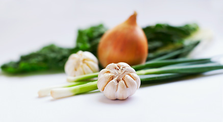 Image showing Vegetable, ingredients and healthy food in studio with garlic, onions and scallions for creativity. Cooking, wellness diet and nutrition with clean, green or vegan meal isolated on a white background