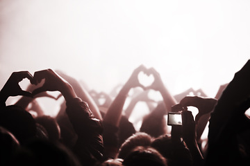 Image showing Hands, heart and phone in the audience with people watching a concert or music festival event. Party, dance or disco with a group of men and women in the crowd while attending a stage performance