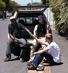 Image showing Fist bump, friends or men chilling in a community together in a van on the road or sidewalk planning as a team. Gangster, outdoor and young hip hop group on the street for the urban culture