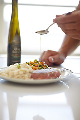 Image showing Diet, food and hands with olive oil for protein meal, food or nutrition on kitchen tablet at home. Hand drizzling oils on vegetables, starch and meat for eating, lunch or cooking healthy dinner