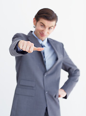 Image showing Hand, vote and thumbs down by unhappy business man in studio with bad news or disappointed on white background. review, fail and male person with negative, feedback and finger emoji for rejection