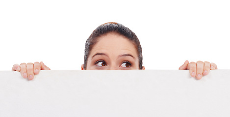 Image showing Eyes, mockup and poster with a woman in studio isolated on a white background holding blank space while thinking. Idea, peek and placard with a young female model advertising on an empty billboard