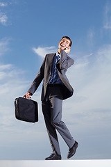 Image showing Happy business man, phone call and sky with briefcase for mobile contact, communication and corporate connection. Male employee walking by clouds, talking on smartphone and mockup networking with bag