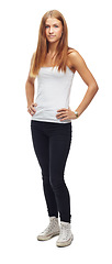 Image showing Portrait, fashion and casual with a woman in studio isolated on a white background standing hands on hips. Teen style, confident and clothing with a young attractive girl model posing arms akimbo