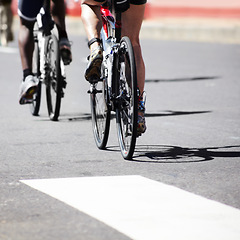 Image showing Bicycle, cycling and feet of a man athlete doing exercise, fitness and workout in a urban street. Race, sport and training cyclist on a road with a bike for competition and wellness outdoor in city