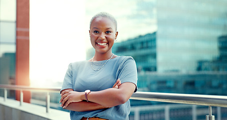 Image showing Black woman in city for business portrait while happy and arms crossed outdoor with vision and pride. Face of entrepreneur person with urban buildings and motivation for career goals as future leader