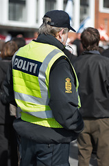 Image showing Safety, protection and security with police officer in city for peace, law enforcement and authority. Emergency services, justice and guard with person in street for help, order and arrest