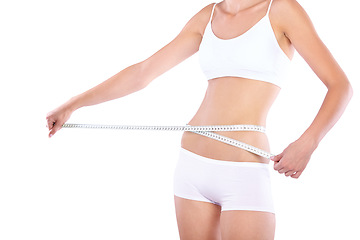 Image showing Hands, measuring tape and woman in studio for weight loss, fitness for wellness, health and white background. Isolated model, girl and underwear with diet, waist and stomach with healthy lifestyle