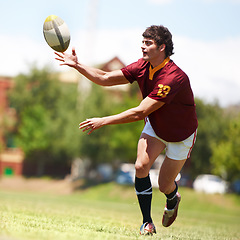 Image showing Man, game and rugby on field for competition by running for fitness or exercise with energy. Male athlete, ball and workout on grass for training with development or growth in sports in the outdoors.