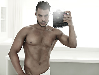 Image showing Mirror selfie, body and a man with a camera in the bathroom of his home for health or hygiene. Photography, wellness and fitness with a handsome young male model posing for a photograph in a towel