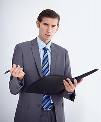 Image showing Confused, portrait and man writing on paper documents in studio for compliance, complaint or discipline on white background. Face, hr and businessman with file for accountability or warning workplace
