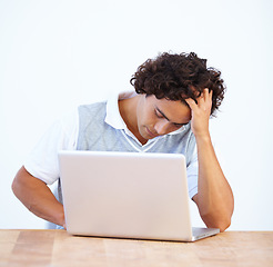 Image showing Frustrated, stress and business man on laptop with networking error, mistake and glitch at desk. Communication, burnout and male worker on computer with stressed out, headache and problem in studio