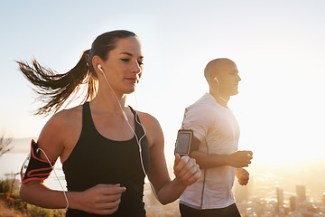 Image showing Sunrise, streaming and fitness couple running as workout or morning exercise for health and wellness together. Sport, marathon and woman runner run with man athlete for training for sports or energy